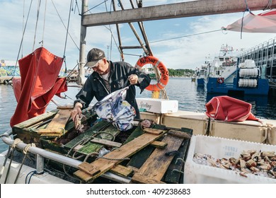 STAVANGER, NORWAY - AUGUST 14, 2015: Fisherman Selling Fishes On His Boat.