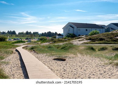 Stavanger, Norway, May 2018: A wooden boardwalk from the beach to Sola Strand Hotel resort and car park in the beginning of summer