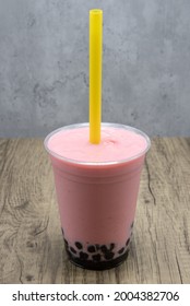 Stawberry Flavored Smoothie With Sweet Tapioca Boba Balls At The Bottom Of The Cup For Flavor.