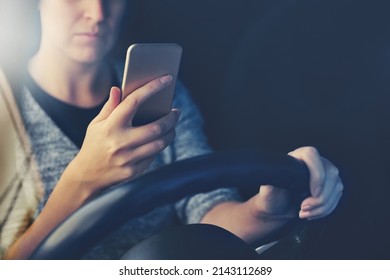 Stay Alive - Dont Text And Drive. Shot Of A Woman Using A Phone While Driving.