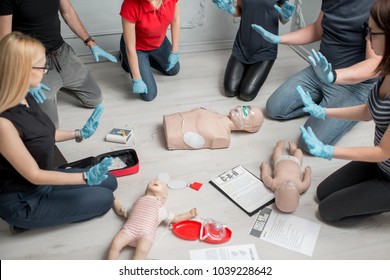 Stay Away Moment During The Defibrillation Process On A First Aid Group Training Indoors