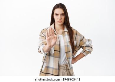 Stay Back. Determined Frowning Woman Stretch Hand In Stop, Block Gesture, Say No, Keep Social Distance During Pandemic, Dont Come Close, Refuse Or Prohibit Something, Disagree, White Background