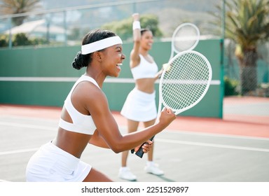 Stay fierce and fight for what you want. Shot of two sporty young women cheering while playing tennis on a court. - Powered by Shutterstock