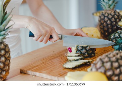 Stay Healthy At Home Concept. Pineapple Sliced By A Girl On The Kitchen Counter. Pineapples Are A Source Of Antioxidants, Reduce Risk Of Chronic Diseases, Heart Disease, Diabetes And Certain Cancers