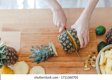 Stay Healthy At Home Concept. Pineapple Sliced By A Girl On The Kitchen Counter. Pineapples Are A Source Of Antioxidants, Reduce Risk Of Chronic Diseases, Heart Disease, Diabetes And Certain Cancers