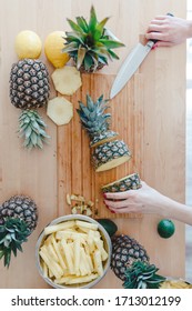 Stay Healthy At Home Concept. Pineapple Sliced By A Girl On The Kitchen Counter. Pineapples Are A Source Of Antioxidants, Reduce Risk Of Chronic Diseases, Heart Disease, Diabetes And Certain Cancers