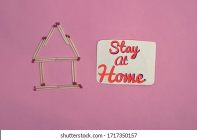 Stay At Home Conceptual Photo Due To Coronavirus (Covid-19) With Match Stick Made House Isolated On Pink Background