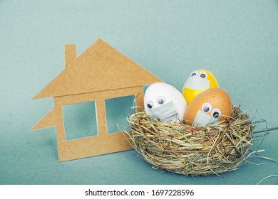 Stay Home At Easter Holiday, Easter Colored Eggs In Face Mask And House Quarantine Concept Celebrate Safely During Coronavirus  Pandemic