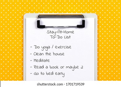 Stay At Home And Quarantine To Do List. Clipboard And White Sheet Of Paper With Text On Yellow Polka Dot Background. Close-up, Top View. 