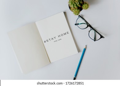 Stay home, stay safe is written on the book For a diary Told about the way to stay at home to not be bored.  concept of self quarantine at home as preventative measure against virus outbreak.