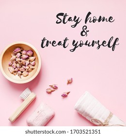 Stay Home And Treat Yourself Concept Text. Spa, Beauty Cosmetics, Body Care Treatment. Creative Top View Flat Lay Bath Accessories, Organic DIY Rose Soap And Dry Flowers In A Bowl On Pink Background