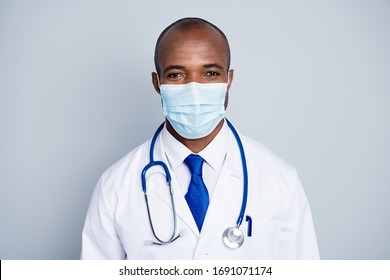 Stay home for us. Photo of family doctor dark skin guy examining patients virologist outbreak wear protective mask white lab coat blue neck tie isolated grey color background