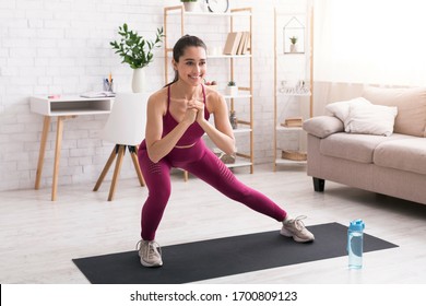 Stay Home Workout. Happy Millennial Girl Doing Lunges On Yoga Mat In Light Room