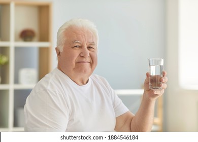 Stay Hydrated, Maintain Salt And Water Balance, Prevent Dehydration. Happy Healthy Senior Man Holding Glass Of Fresh Water. Concept Of Elderly People Developing Good Habit Of Drinking Enough Liquid