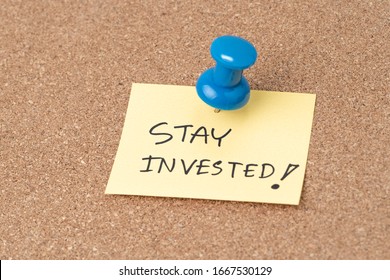 Stay Invested, Investment Decision Idea To Stay The Course When Stock Market Crisis Concept, Thumbtack Or Pushpin Pin To Small Paper Note Written Stay Invested.