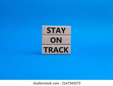 Stay on track symbol. Wooden blocks with words 'Stay on track'. Beautiful blue background. Business and 'Stay on track' concept. Copy space. Conceptual image
