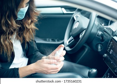 Stay Safe Stock Photo.Woman In Protective Mask Sitting In A Car, Using Hand Sanitizer