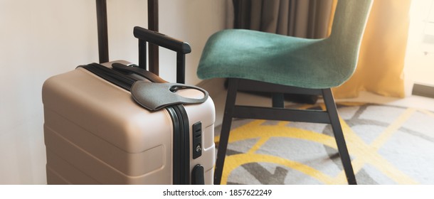 Stay Safe While Travel During Covid 19 Pandemic Concept. A Suitcase Or Baggage With A Medical Face Mask In The Hotel Room. Travel Bubbles, Business Trip, ASQ Alternative State Quarantine, New Normal.