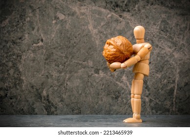 Stay Strong Concept. Dummy Holds Kernel Of Walnut In His Hands. Motivational, Business And Stay Strong Concept.