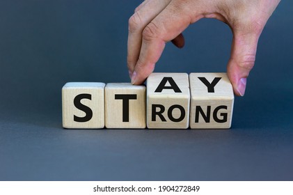 Stay Strong Symbol. Businessman Turns Cubes With Words 'stay Strong'. Beautiful Grey Background. Motivational, Business And Stay Strong Concept. Copy Space.