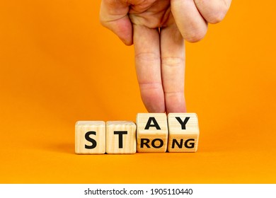 Stay Strong Symbol. Businessman Turns Cubes With Words 'stay Strong'. Beautiful Orange Background. Motivational, Business And Stay Strong Concept. Copy Space.
