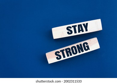 Stay Strong Symbol. Wooden Blocks With Words 'stay Strong'. Beautiful Blue Background. Copy Space. Motivational, Business And Stay Strong Concept.