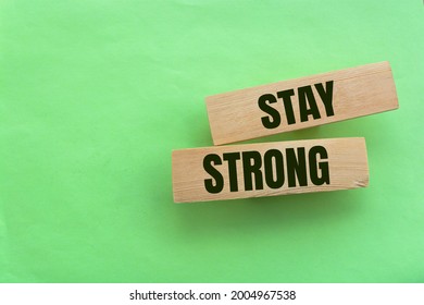 Stay Strong Symbol. Wooden Blocks With Words 'stay Strong'. Beautiful Green Background. Copy Space. Motivational, Business And Stay Strong Concept.