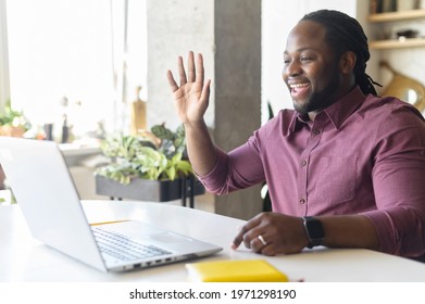 Stay In Touch With Work Team During Quarantine. African-American Guy Using Laptop For Video Connection, Waving Hi Into Webcam, Involved Video Meeting With Colleagues, Greeting Participants Online