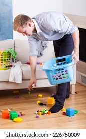 Stay-at-home Dad Cleaning Up Drawing Room