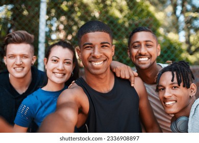 Staying active automatically makes you happier too. Portrait of a group of sporty young people taking selfies together outdoors.