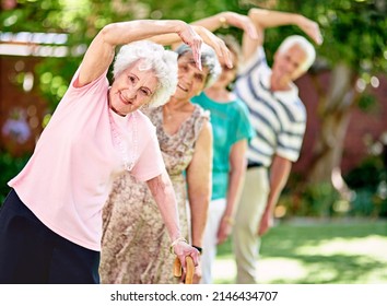 Staying active is key to a healthy retirement. Shot of a group of smiling seniors exercising outside. - Powered by Shutterstock