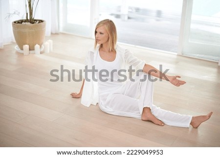 Staying fit physically and mentally. Full length shot of a young blonde woman doing yoga.
