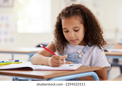 Staying focused in class. Shot of a preschooler colouring in class. - Powered by Shutterstock