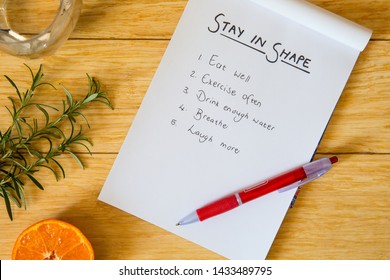 Staying good shape physically and mentally motivation. Handwritten list with things to do to keep your mind and body healthy.  This to do list includes a holistic approach to stay healthy. Flat lay.