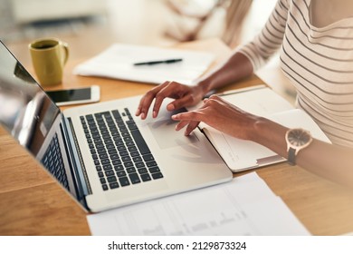 Staying On Top Of Things. Cropped Shot Of An Unrecognizable Woman Working On Her Laptop At Home.