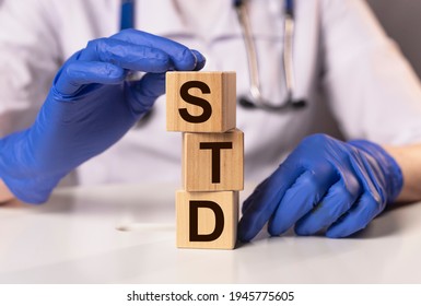 STD Acronym Inscription On Wooden Cubes In Doctor Hands.