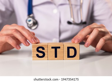 STD Acronym Inscription On Wooden Cubes In Doctor Hands.