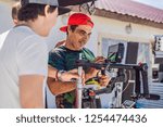Steadicam operator prepare camera and 3-axis stabilizer-gimbal for a commercial shoot
