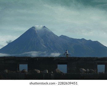 With steady hands and a cautious step, the elderly man leads his bike across the bridge, the sound of rushing water below.