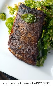 Steak Braised In Organic Butter, Garlic And Served  With Jumbo Lump Crab Cake, Cauliflower, Broccoli And Potatoes. Classic American Steakhouse Restaurant Or French Bistro Entree Favorite.