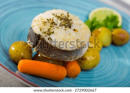 Steak of cod by rustically frying and served with boiled potatoes, carrots and greens
