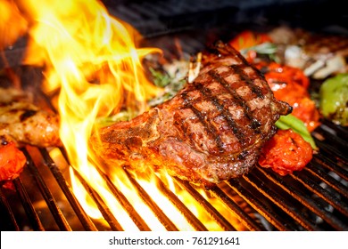 Steak Cooking On Fire With Vegetables