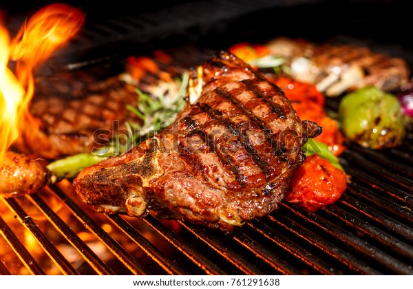 steak cooking on fire\
with vegetables