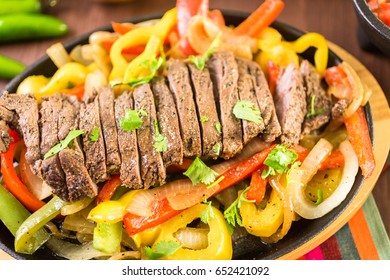 Steak Fajitas With Bell Peppers And Yellow Onion On A Cast Iron Fajita Skillet.