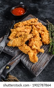 Steak Fingers Fried Breaded Chicken Breast Strips. Black Background. Top View.