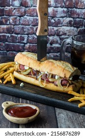 Steak Hoagie Bun With A Knife, Served With Fries And Ketchup.