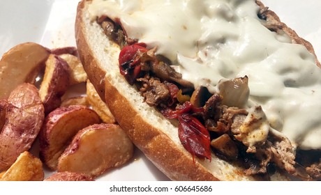 Steak Hoagie Sandwich With Mushrooms Peppers And Cheese With Potatoes