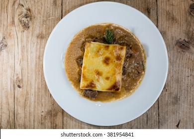 Steak And Kidney Pie From Above. French Restaurant Prepared Cuisine Influenced By A Traditional English Recipe, Presented On A White Plate