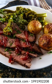 Steak and new potatoes with honey mesquite barbecue sauce and garlicky broccoli rabe - Shutterstock ID 1991902208