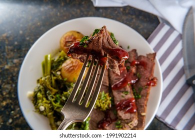 Steak and new potatoes with honey mesquite barbecue sauce and garlicky broccoli rabe - Shutterstock ID 1991902214